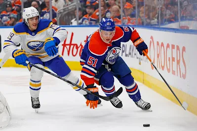 Edmonton Oilers defenseman Troy Stecher carries the puck during 2025 game.